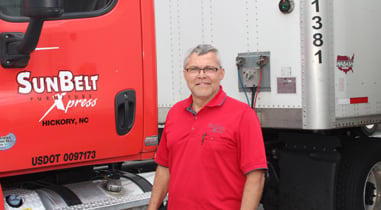 SunBelt employee standing in front of a truck