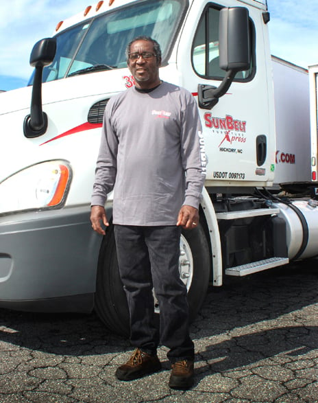 SunBelt employee standing in front of a truck